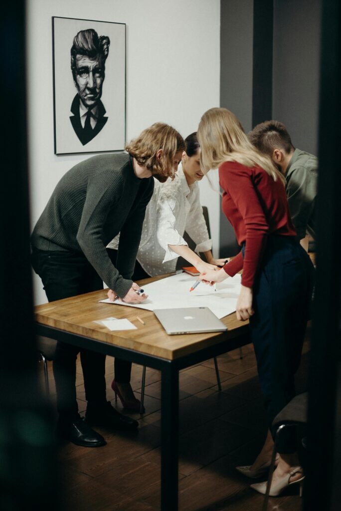 Group of diverse professionals brainstorming ideas in a stylish modern office space.